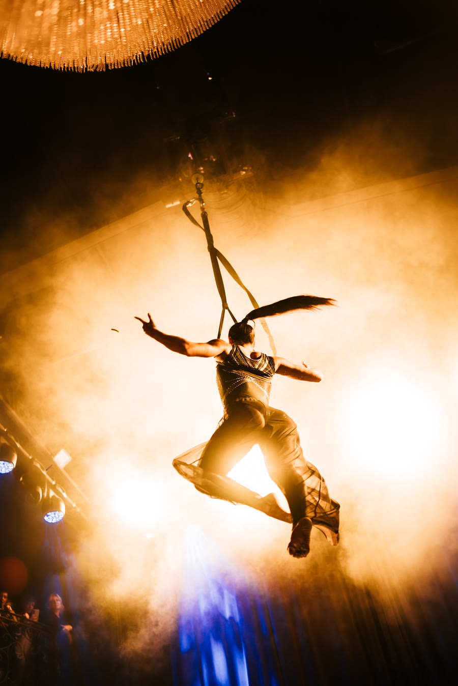 Aerial straps performance showing strength and flexibility high above the stage