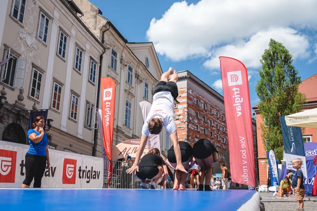 Participant doing a cartwheel on the air track while others wait for their turn