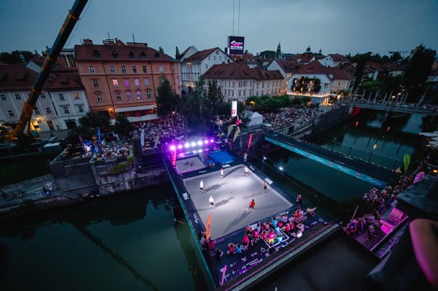 Night view from above of the trampoline stage on the river surrounded by spectators